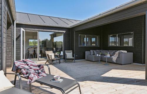 a patio with chairs and a table and a couch at Stunning Home In Ålbæk With Sauna in Ålbæk