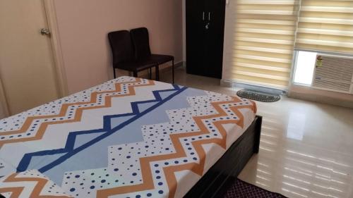 a bedroom with a bed and a chair in a room at RiShi in Lucknow