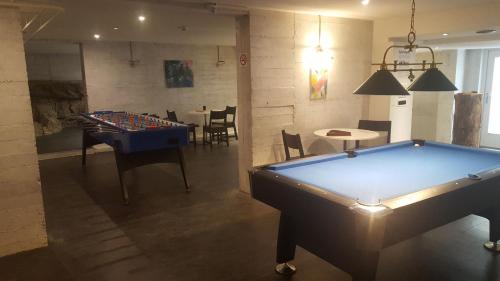 a room with a pool table and a dining room at B&B Hotel Mattli Übernachtung Frühstück in Morschach