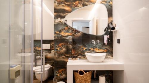 a bathroom with a sink and a mirror at Meteora Smart Suites in Kalabaka