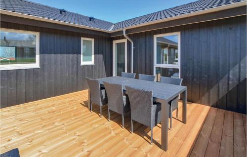 a patio with a table and chairs on a deck at Four-Bedroom Holiday Home In Nordborg in Nordborg