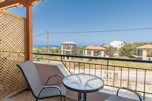 a balcony with a table and chairs and a view of the ocean at Spiros house in Svoronata