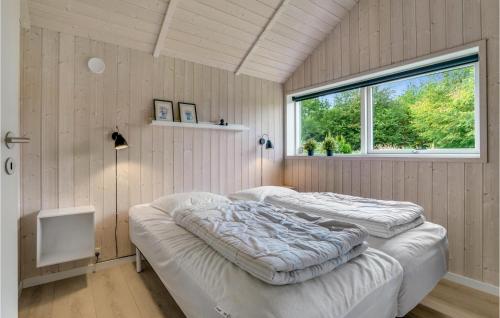 two beds in a room with a window at Lovely Home In Hobro With Wifi in Hobro
