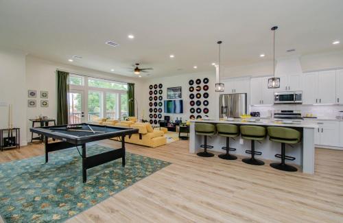 a kitchen and living room with a ping pong table at 3bd-Rooftop Movie Theater-BBQ-Retro Music Theme-Downtown 8mins in Houston