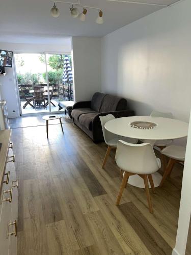 un salon avec un canapé et une table dans l'établissement Mylilou location, au Cap d'Agde