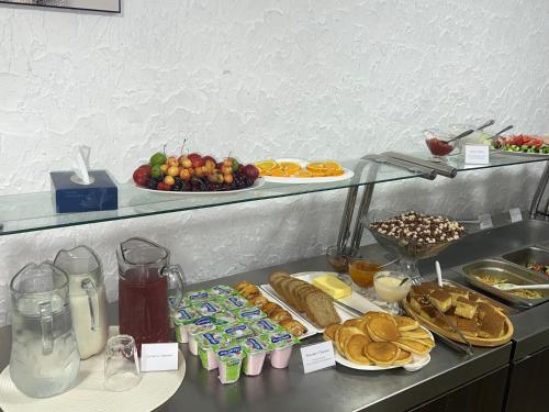 a buffet with different types of food on a table at Hotel Tigran Mets Yerevan in Yerevan