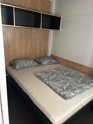 a bed in a small room with a bed sqor at Villa Kiara in Vodice