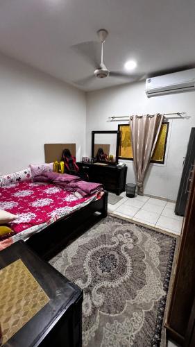 a bedroom with a bed and a table and a rug at Offer if booked at least 1 week Elegance Modern 1-Bedroom Close to Everything in Ajman 