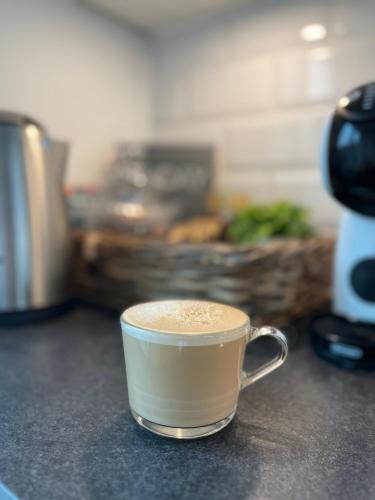 a cup of coffee sitting on a counter at Holiday apartment with ocean view in Svendborg