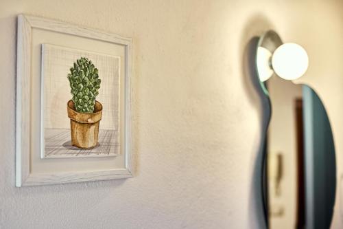 a picture of a plant in a picture frame on a wall at La Casa di Nonna Danda in Montepulciano