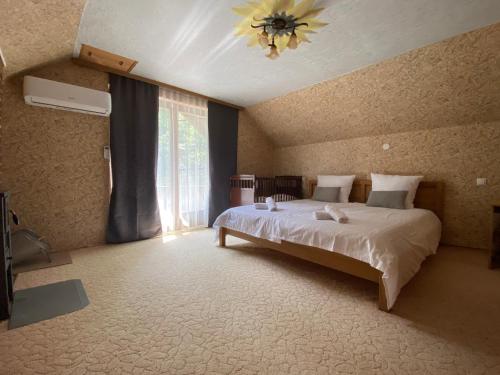 a bedroom with a large bed and a window at Forest House between Sarajevo & Vlasic in Busovača