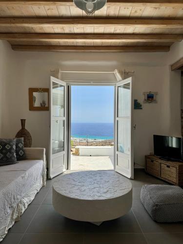 a bedroom with an open door with a view of the ocean at Villa Anna in Elia Beach