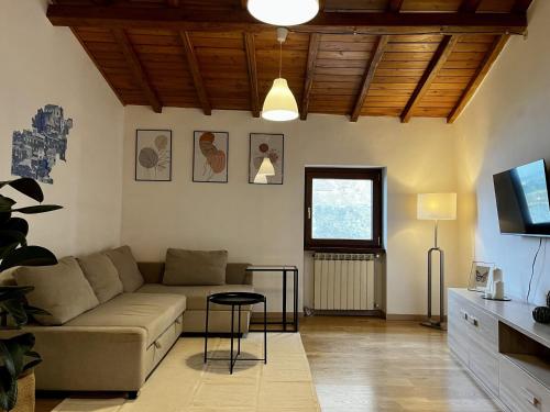 a living room with a couch and a table at Eleganza in Centro sul Lago - Anguillara Sabazia in Anguillara Sabazia