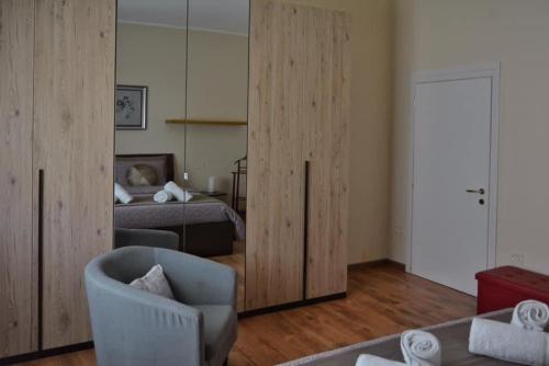 a room with a bedroom with a bed and a chair at Due passi dal Te in Mantova
