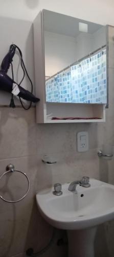 a bathroom with a white sink and a mirror at LA ÑATA in Concepción del Uruguay