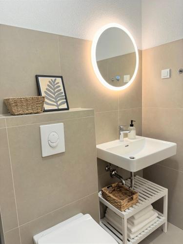 a bathroom with a sink and a mirror at Olive Garden in Promajna