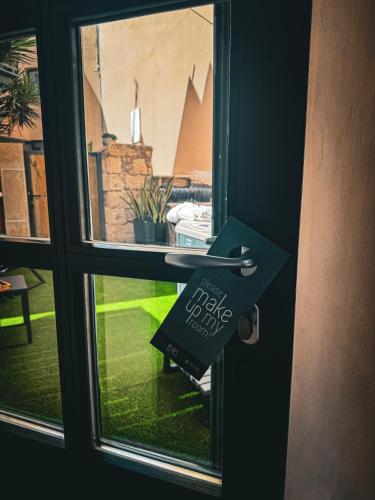a door with a sign that reads help needed at Ink Hotels House of Europe in Rethymno Town