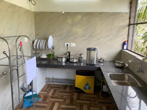 a kitchen with a sink and a counter top at Dream inn in Meenangadi