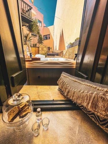 a table with a glass plate of food on a counter at Ink Hotels House of Europe in Rethymno Town
