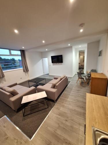a living room with a couch and a table at Centre of the town in Whitchurch