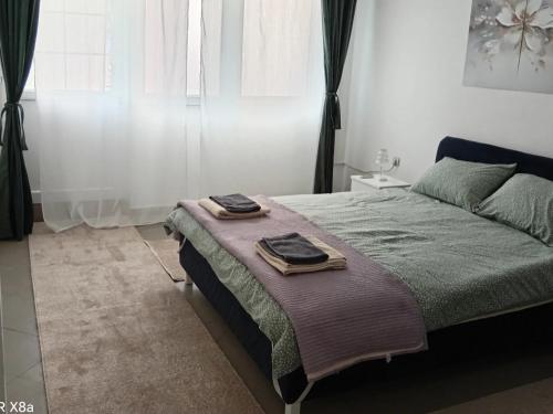 a bedroom with a bed with two towels on it at Predah Vranje in Vranje
