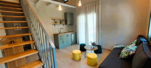 a living room with a couch and a staircase at PargaMondo Countryliving in Parga