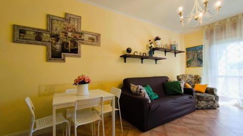 a living room with a couch and a table at Rome Sweet Home in Vitinia