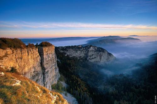 a view of a mountain with clouds in the valley at Appartement thématique Art Moderne in Travers