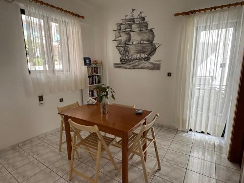 a dining room with a wooden table and chairs at Argiro's apartment at Agia Galini in Agia Galini