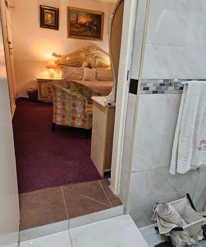 a bathroom with a shower and a bedroom at The Royal Princess B&B on Malibongwe Drive in Johannesburg