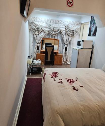 a bedroom with a bed with roses on it at The Royal Princess B&B on Malibongwe Drive in Johannesburg