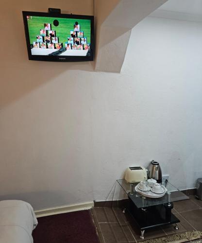 a room with a tv hanging on the wall at The Royal Princess B&B on Malibongwe Drive in Johannesburg