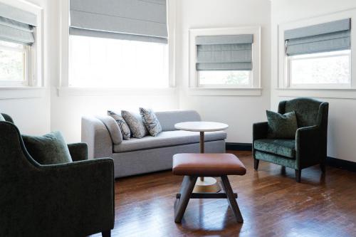 a living room with a couch and two chairs and a table at The Sagaponack in Sagaponack