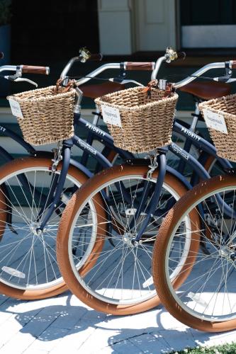 three bikes with wicker baskets are parked next to each other at The Sagaponack in Sagaponack