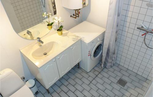 a bathroom with a sink and a washing machine at 2 Bedroom Gorgeous Home In Hasle in Hasle