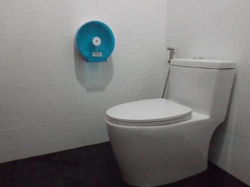 a bathroom with a toilet with a blue plate on the wall at Lanta Long Beach Hostel in Ko Lanta