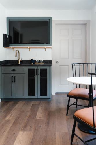 a kitchen with a sink and a table with chairs at The Sagaponack in Sagaponack