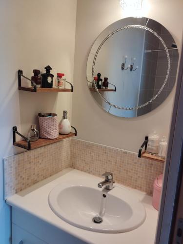 une salle de bain avec un lavabo et un miroir dans l'établissement Maison Centre bourg, à Nort-sur-Erdre