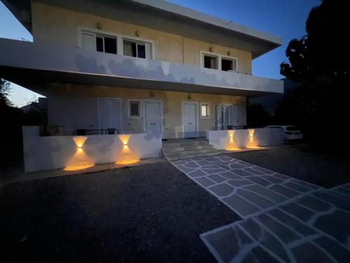 a house with lights in front of it at Nafpaktos PebBle Apartments in Marathias in Marathiás