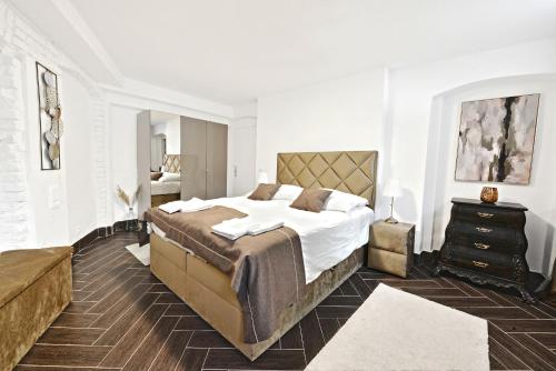 a bedroom with a large bed with white walls at Lux Central Apartment in Berlin