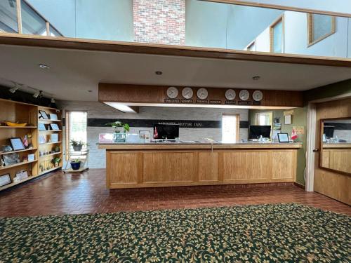 a large room with a counter in a building at Airport Motor Inn in Marathon