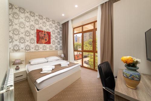 a hotel room with a bed and a window at Amea Baku Hotel in Baku