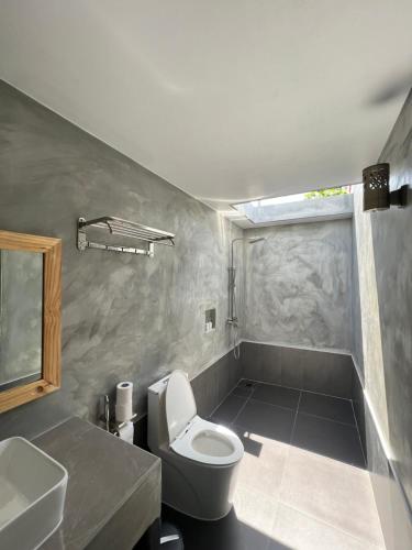 a bathroom with a toilet and a sink at Manta Stay Thoddoo, Maldives in Thoddoo