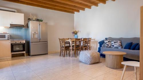 a kitchen and living room with a couch and a table at Τhemis House in Chania Town