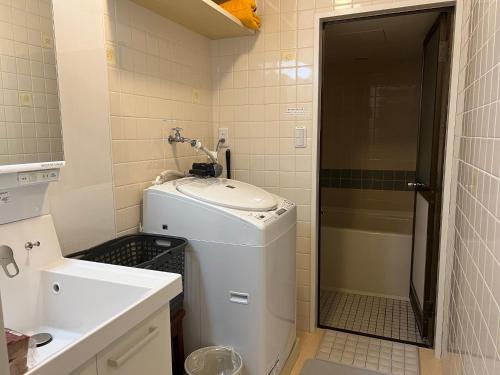 a small bathroom with a sink and a shower at Marina Bay Atami in Atami