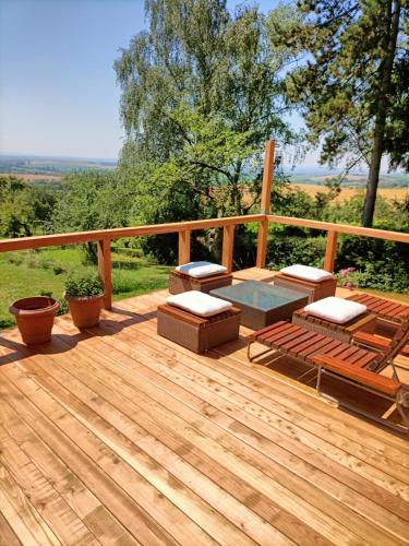 a wooden deck with a table and chairs on it at Vacation Home Pani haje in Moravany