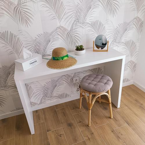 a white table with a hat and a stool at House Inga in Pirovac