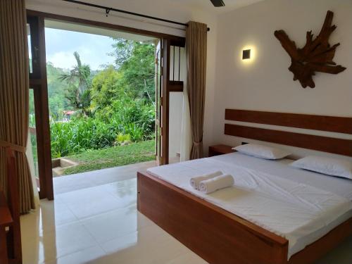 Postel nebo postele na pokoji v ubytování Kandy Lotus Chalet