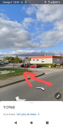 a picture of a red arrow on a street at Le Colibri in Saint-Jean-de-Losne