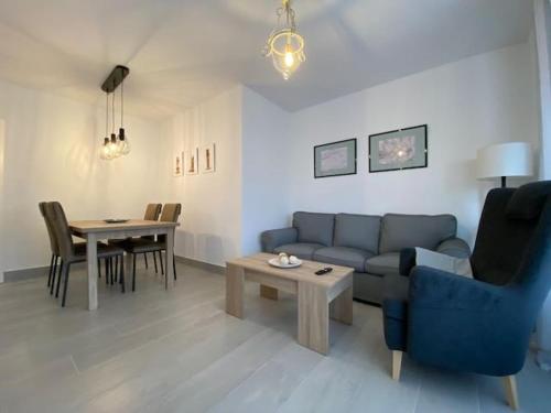 a living room with a couch and a table at Vistahermosa-El ancla in El Puerto de Santa María